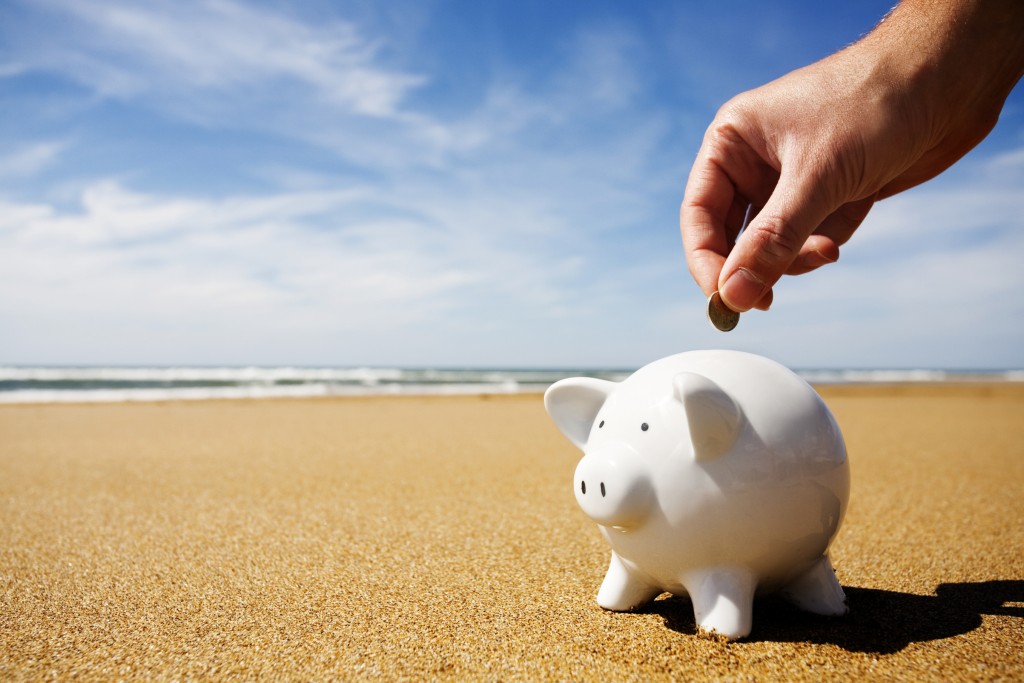 Piggy bank being filled at the seaside