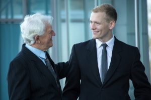 Young happy employee talking with his boss