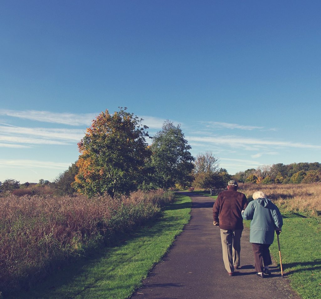 An elderly couple walking. Making sure they have an up-to-date will. 